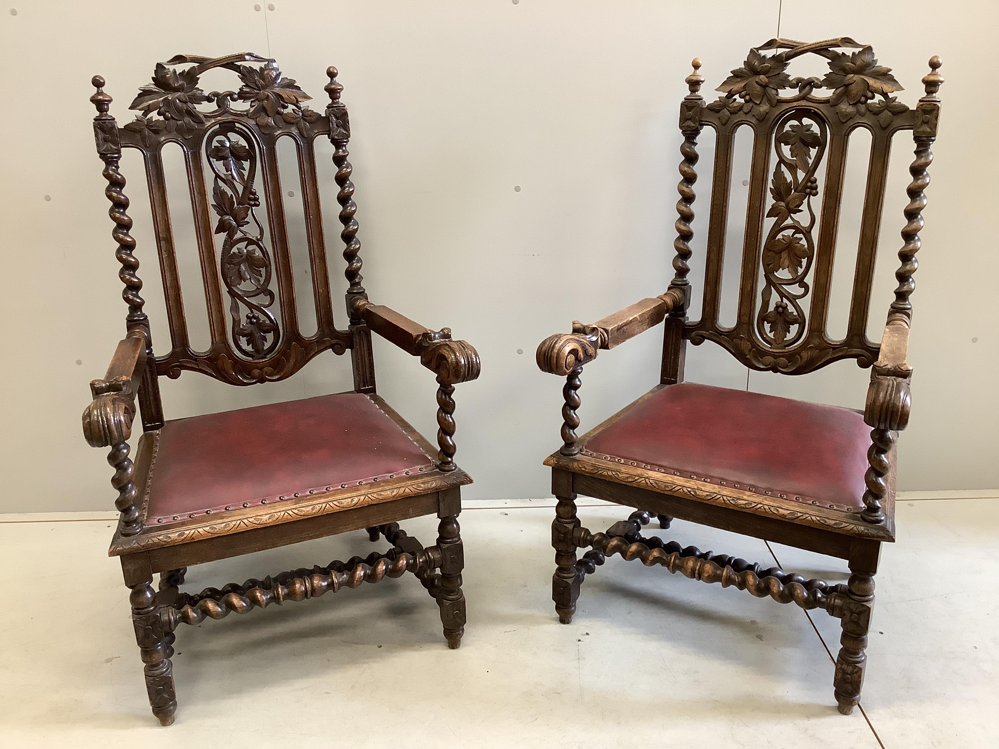 A pair of late Victorian carved oak elbow chairs, width 69cm, depth 63cm, height 122cm
